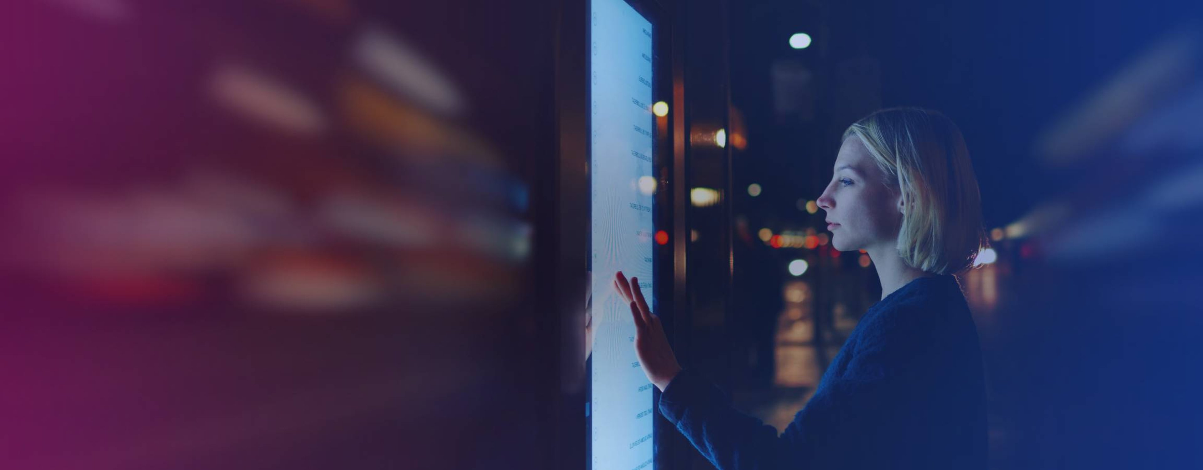 Woman looking at a touchscreen monitor